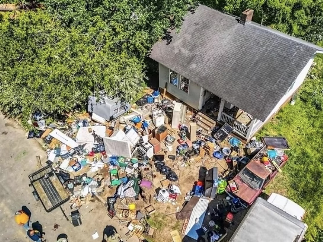 Aerial view of a property with discarded household items and debris outside